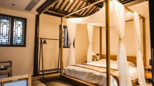 Letto o letti in una camera di Yangzhou Aihehua Boutique Homestay