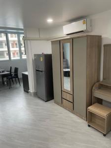 an office room with a refrigerator and a table at My Home in Patong Beach