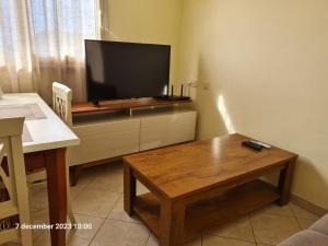 a living room with a tv and a coffee table at Plaza Top floor apartment in Santa Maria