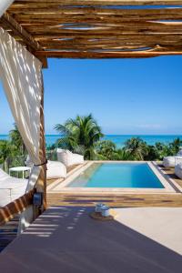 a swimming pool with a view of the ocean at Mero Mero Hotel in El Cuyo