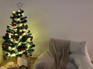 a christmas tree in a living room next to a couch at Arte Cheras Designer Suite by Moka @ Cheras in Kuala Lumpur +76 photos