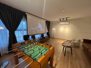 a living room with a pool table and a tv at Arte Cheras Designer Suite by Moka @ Cheras in Kuala Lumpur