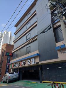 a building with a sign on the side of it at On & Off Hotel Bupyeong in Incheon