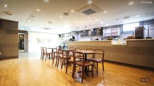 a restaurant with chairs and a table and a counter at Hotel Terramar in Boryeong