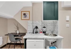 a kitchen with a sink and a counter at Serene Bliss: Perfect Studio For 2 in London