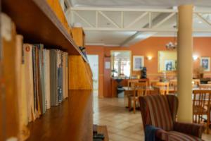 a row of books on a shelf in a restaurant at Broadway Boston in Cape Town