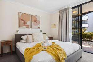 a bedroom with two beds with a yellow blanket at Riverside Elegance Central 1BR 1BA Apartment in Perth