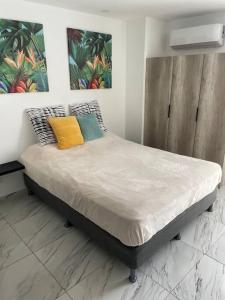 a bed with two pillows on it in a room at Studio Panama in Panama City