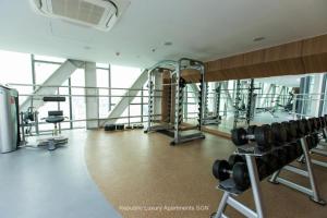 a gym with a bunch of equipment in a building at Republic Apartment Nearby Airport Free Pool Gym in Ho Chi Minh City