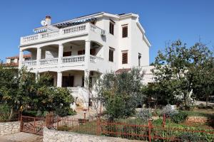 a white house with a fence in front of it at Apartments Ankica - 150 m from beach in Zadar