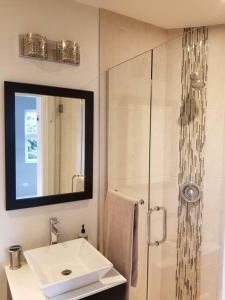a white bathroom with a sink and a shower at Nice and cozy. Sleeps 5. in Chicago