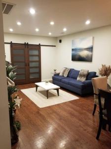 a living room with a blue couch and a table at Nice and cozy. Sleeps 5. in Chicago