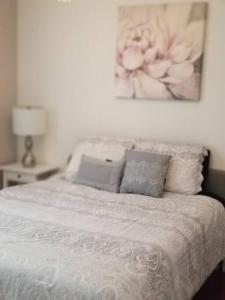 a bed with two pillows and a picture on the wall at Nice and cozy. Sleeps 5. in Chicago