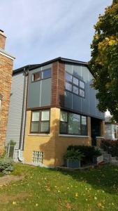 a large house with glass windows on a yard at Nice and cozy. Sleeps 5. in Chicago