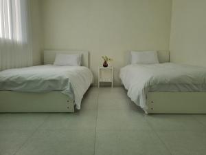 two beds sitting next to each other in a room at hongdae Gangnam line 2 st 1 min in Seoul