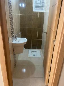 a small bathroom with a sink and a toilet at Ecemsuit2 in Yomra +13 photos