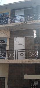 a building with a white door and a balcony at KEERTHISH NIVAS Home stay in Tiruvannāmalai