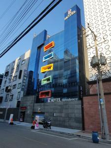 a building with a reflection of a hotel at Residence R Hotel in Daegu