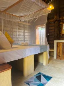 Cama grande en habitación con ventana en Windy Waves Kite Beach & Nature Resort, en Kalpitiya