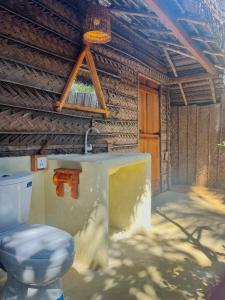 a bathroom with a toilet and a sink at Windy Waves Kite Beach & Nature Resort in Kalpitiya