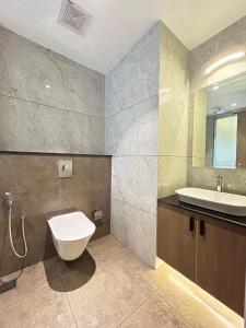 a bathroom with a white toilet and a sink at VAGA NAKSHATHRA SUITES in Vagamon