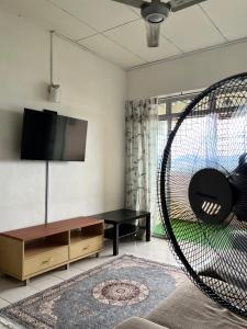 a living room with a couch and a swing at Homestay Vista3A at Vista Seri Putra in Kajang