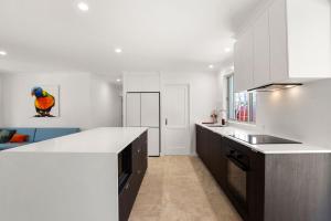 a kitchen with white walls and a white counter top at Browning Boulevard 9, Battery Hill in Caloundra +5 photos