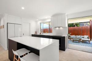 a kitchen with white cabinets and a white counter top at Browning Boulevard 9, Battery Hill in Caloundra