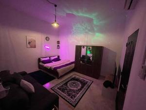 a room with a bed and a couch in a room with auroras at Remas's Studio in Corniche Abu Dhabi in Abu Dhabi