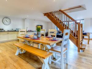 a kitchen and dining room with a wooden table and chairs at 3 bed in Fowey 53664 in Warleggan