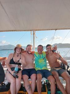 a group of people sitting on a boat at Footprints Hostel in Coron