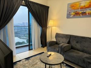 a living room with a couch and a large window at Reizz Residence by Perkasa in Kuala Lumpur