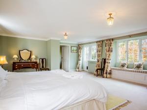 - une chambre avec un grand lit blanc et des fenêtres dans l'établissement 4 Bed in Truro 75546, à Ladock