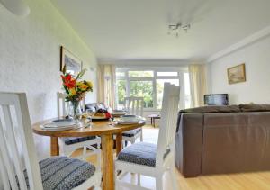 a living room with a table and a couch at Sandy Reach ( Croft Court ) in Tenby