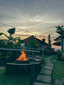 a fire pit with a person standing next to it at Moondock Luxury Camp in Munduk