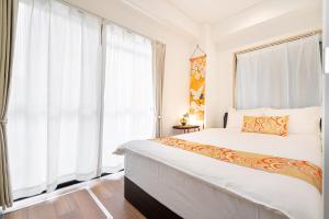Ένα ή περισσότερα κρεβάτια σε δωμάτιο στο KYARA Hotelミスミ301