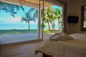 a bedroom with a view of the ocean with a bed at Siam Beach Resort in Ko Chang