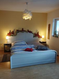 a bedroom with a large bed with a large headboard at Haus WoogArt in Dahn