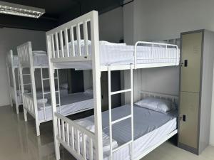 a group of bunk beds in a room at PJ Hostel in Pak Chong