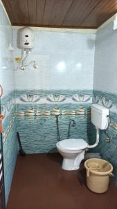 a bathroom with a toilet and a sink at Gokarna Govekar Sea Facing Rooms in Gokarn