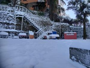 a staircase covered in snow in front of a building at Glen View Heritage Homestay in Shimla