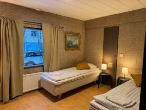 a bedroom with two beds and a window at Apartment HILLI in Rovaniemi