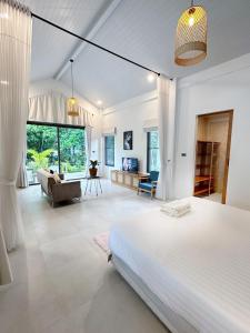 a bedroom with a large bed and a living room at Crystal 7 in Haad Tian