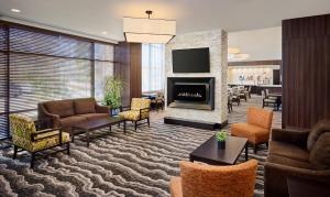 a lobby with a living room with a fireplace at Staybridge Suites Niagara-On-The-Lake, an IHG Hotel in Niagara on the Lake