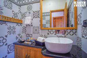 a bathroom with a large sink and a mirror at StayVista at Wandering Hills in Pālampur