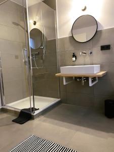 a bathroom with a sink and a shower at Alte Seifensiederei - Fabienne in Bad Tölz