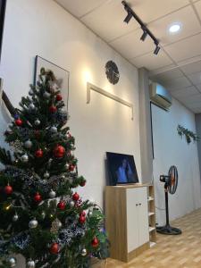 a christmas tree in a room with a camera at HOUSE FOR ALL - CANTHO HOMESTAY in Can Tho