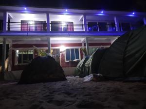 a group of tents in front of a house at night at Gokarna Govekar Sea Facing Rooms in Gokarn