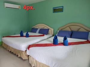 Postel nebo postele na pokoji v ubytování Pranpai
