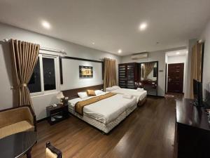 a bedroom with a large bed and a television at Hotel No 9 Nguyễn Trường Tộ - by Bay Luxury in Hanoi